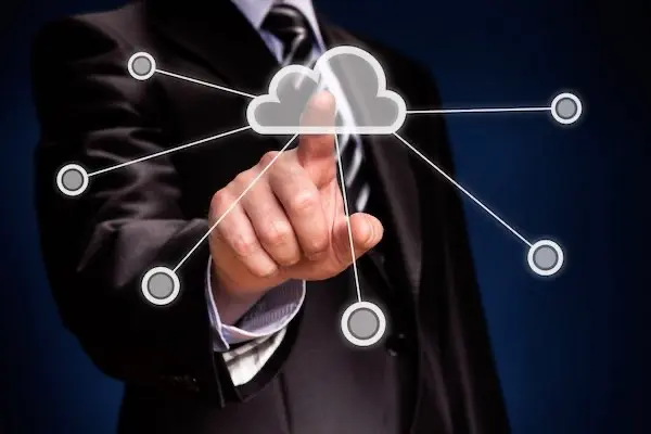 Businessman interacting with cloud technology interface.